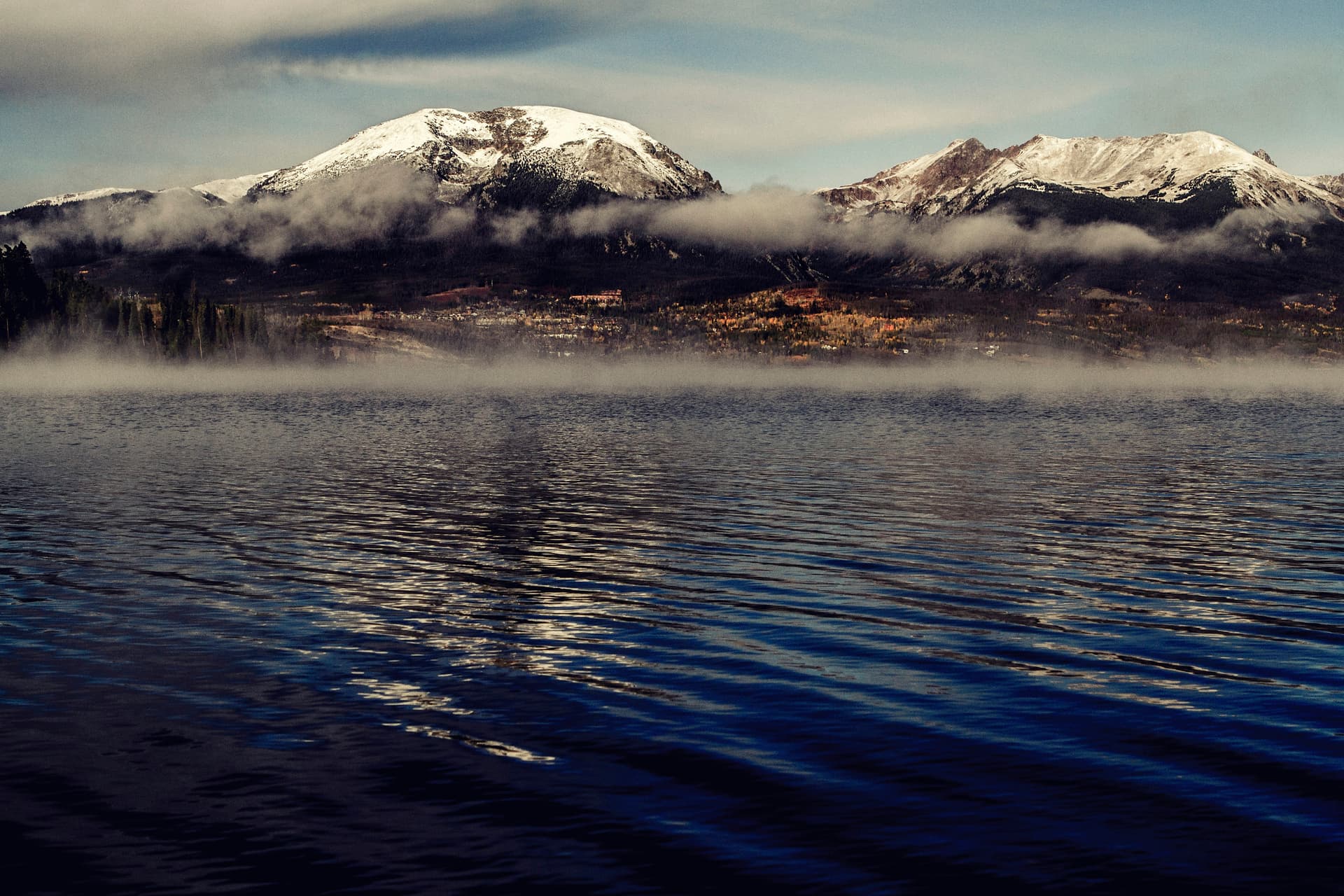 Snow-capped peaks above morning mist on Dillon Reservoir