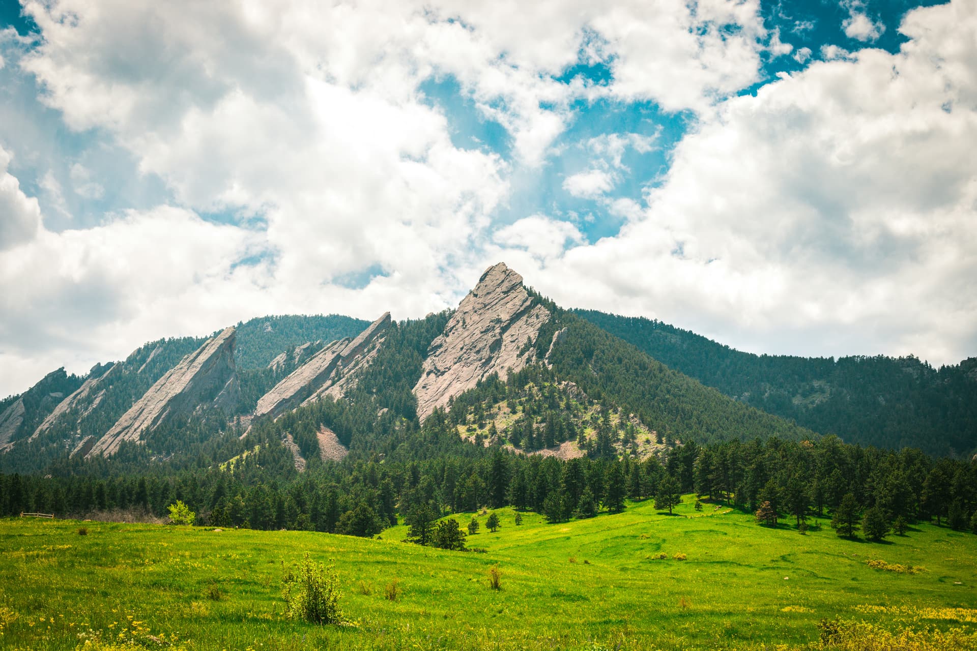 Green Chautauqua meadow beneath the Flatirons in Boulder