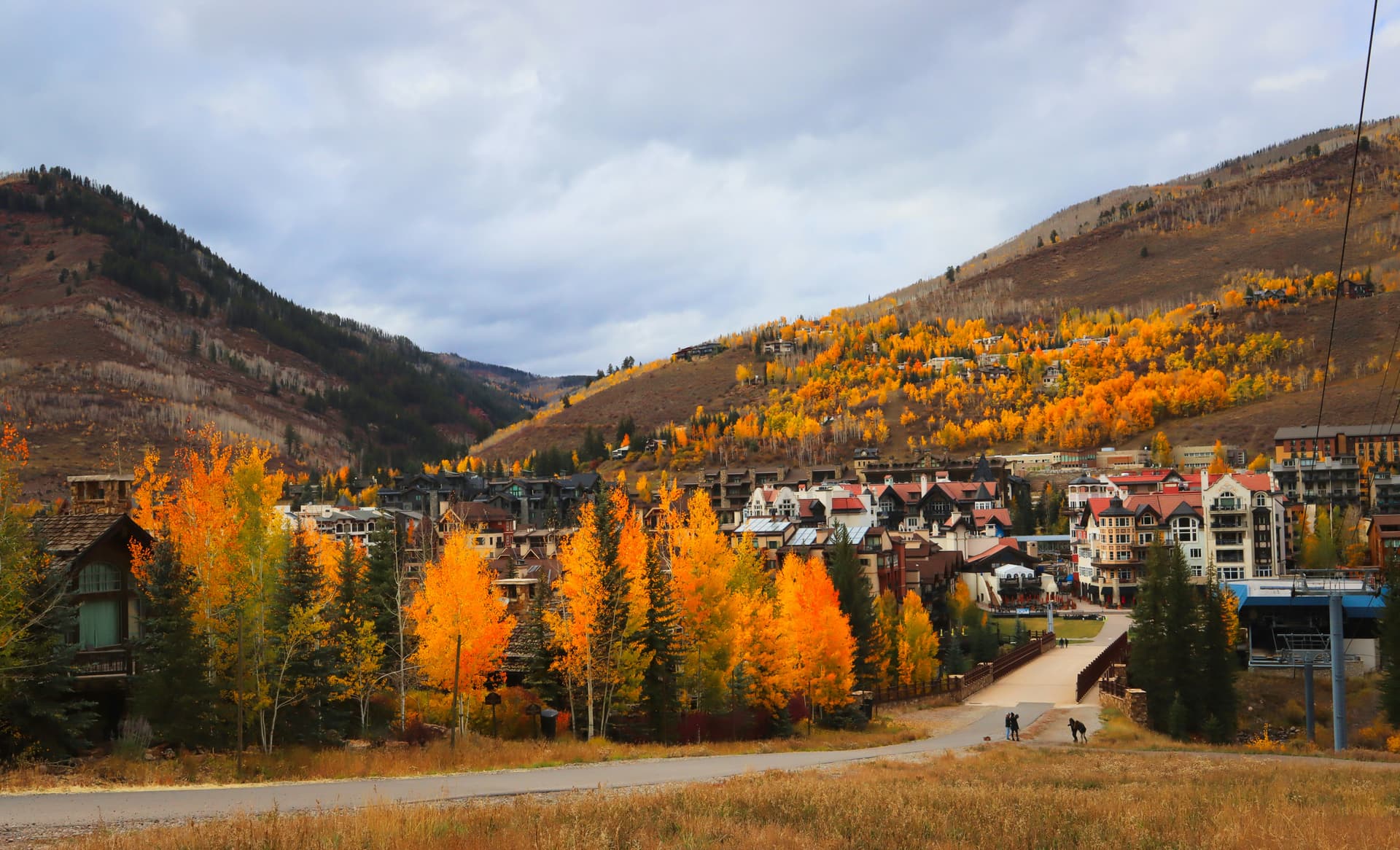 Vail's lodges and condos beneath golden fall aspens on the valley slopes